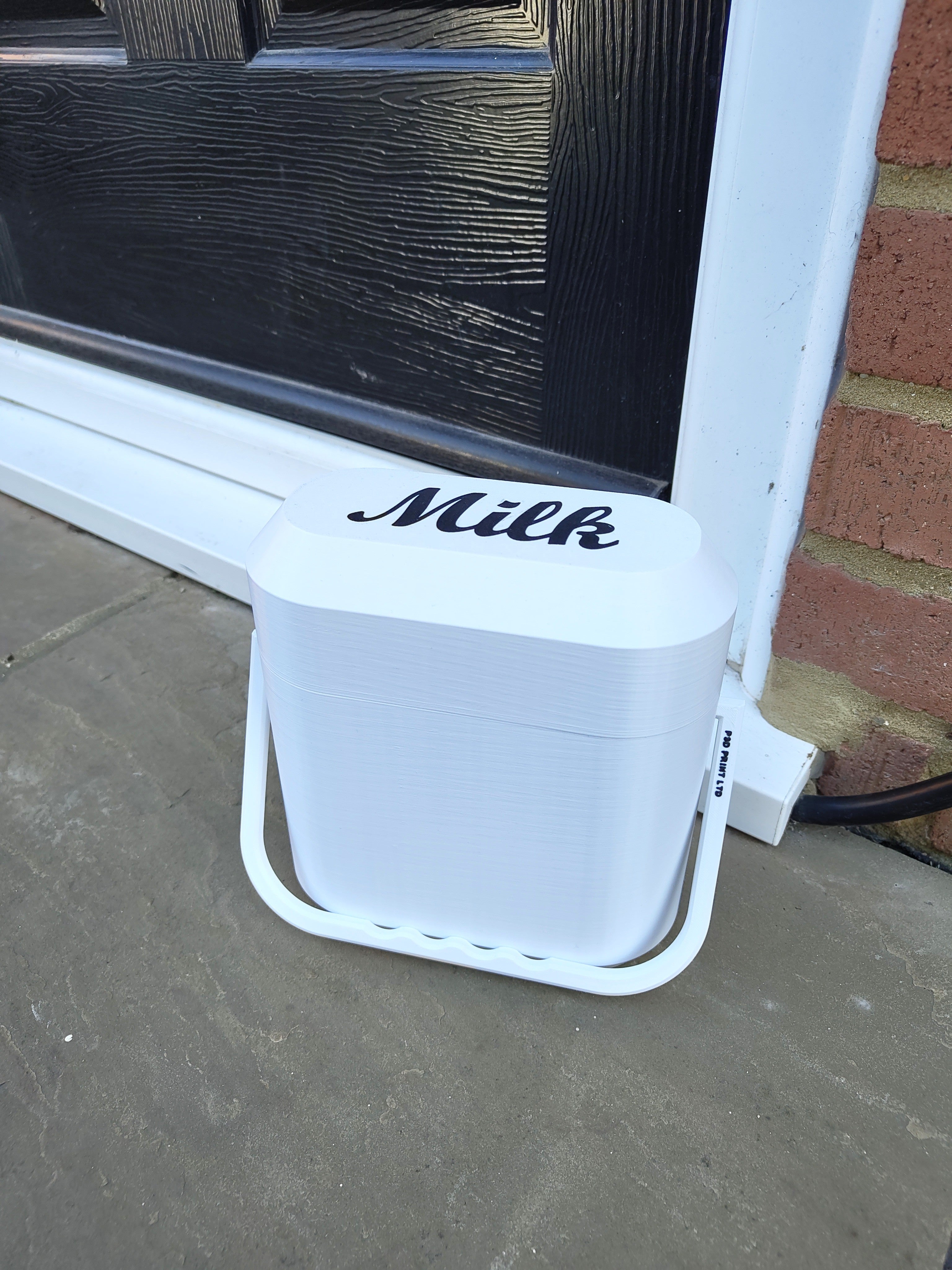 White milk container with 'Milk' label on a doorstep