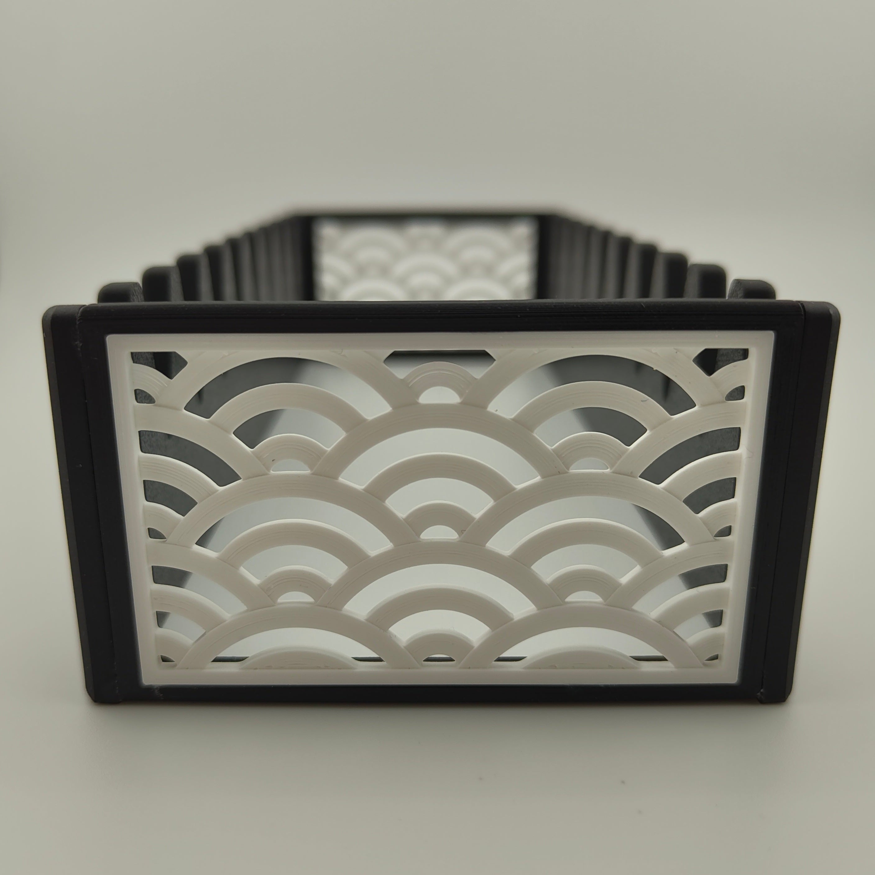 A black scissor organiser with a white Japanese wave pattern