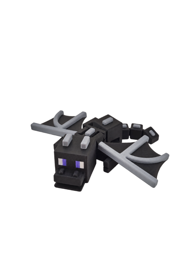 A black and gray toy dragon figure with purple eyes, resembling a Minecraft-style creature, shown on a plain white background.