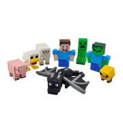 A set of Minecraft-themed toy figurines and small blocks arranged on a plain white background. The set includes a Steve character, a creeper, a zombie, a pig, a chicken, a sheep, a yellow chick, and a black-and-gray dragon.
