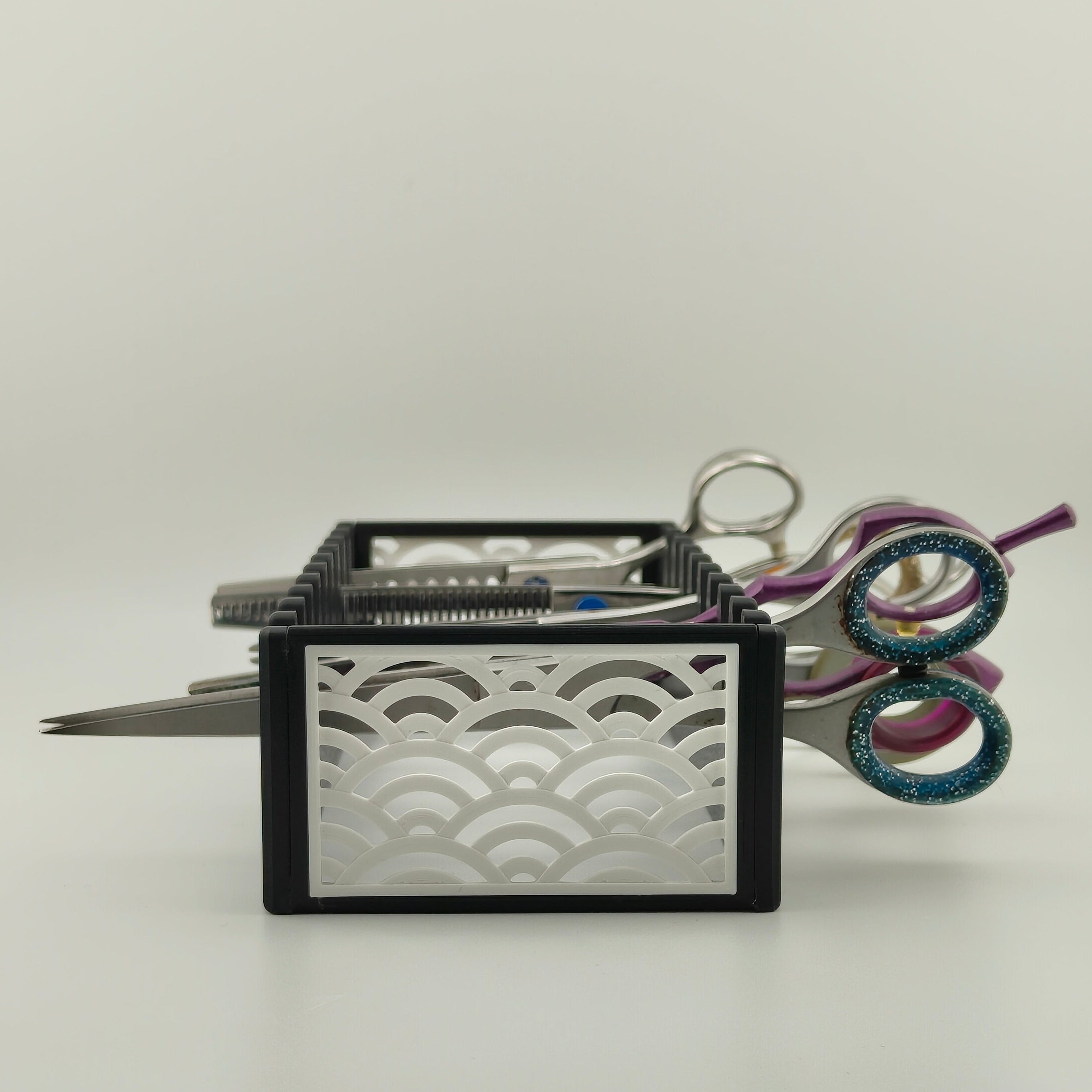 A black scissor organiser with a white Japanese wave pattern