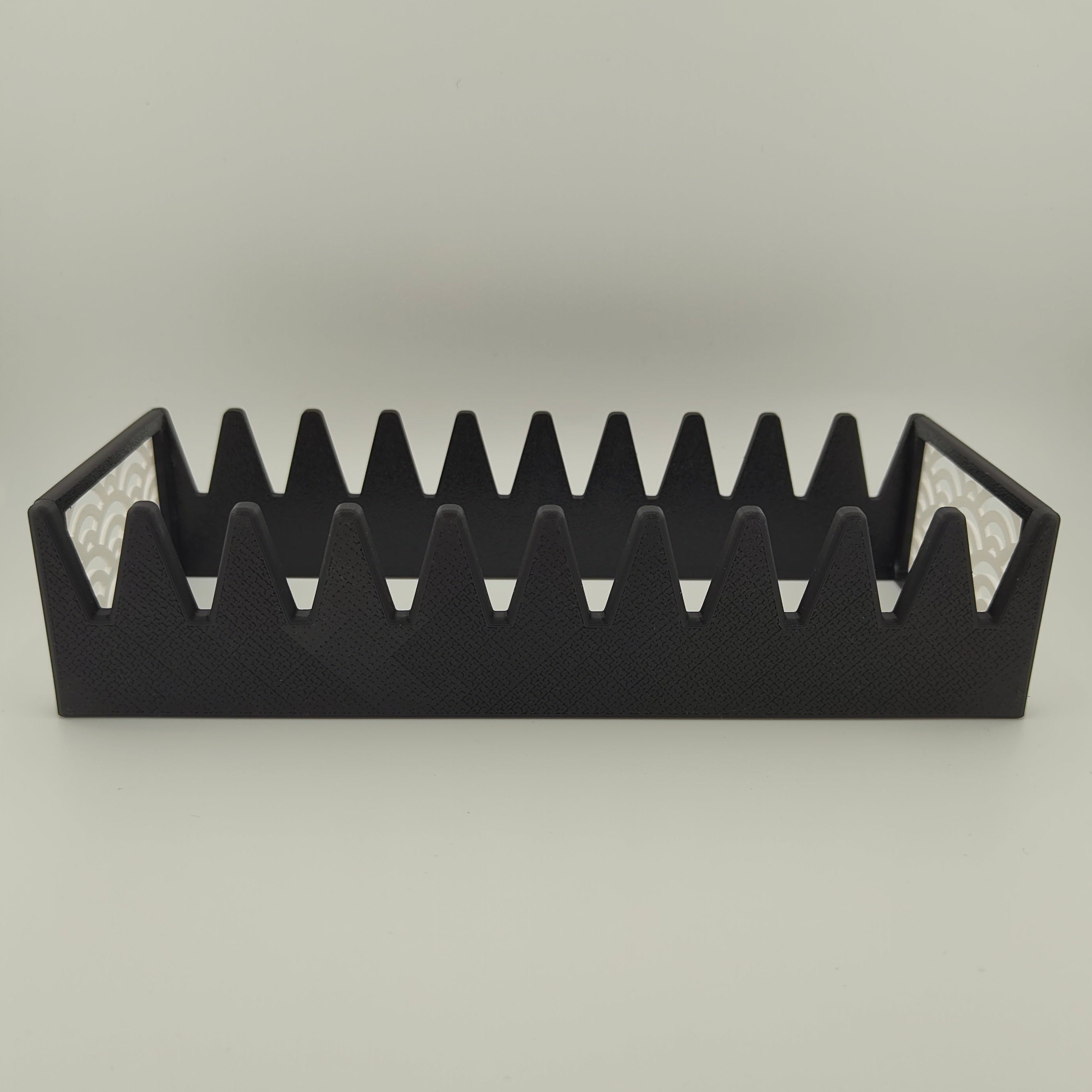 A black scissor organiser with a white Japanese wave pattern