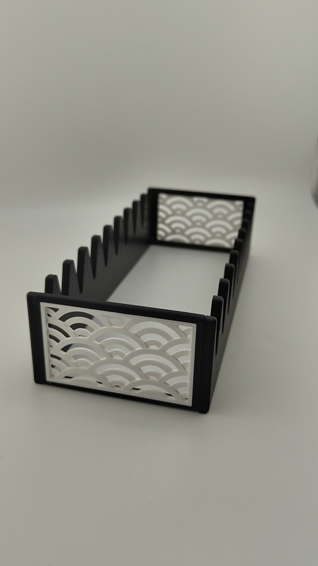 A black scissor organiser with a white Japanese wave pattern